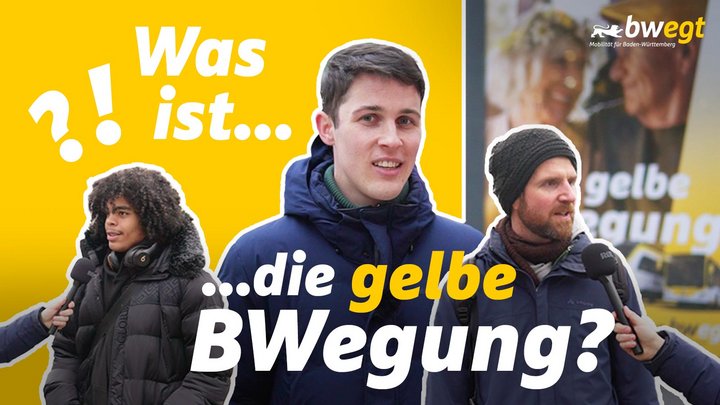 Drei Personen stehen im Vordergrund des Bildes. Zwei von ihnen wird ein Mikrofon hingehalten.