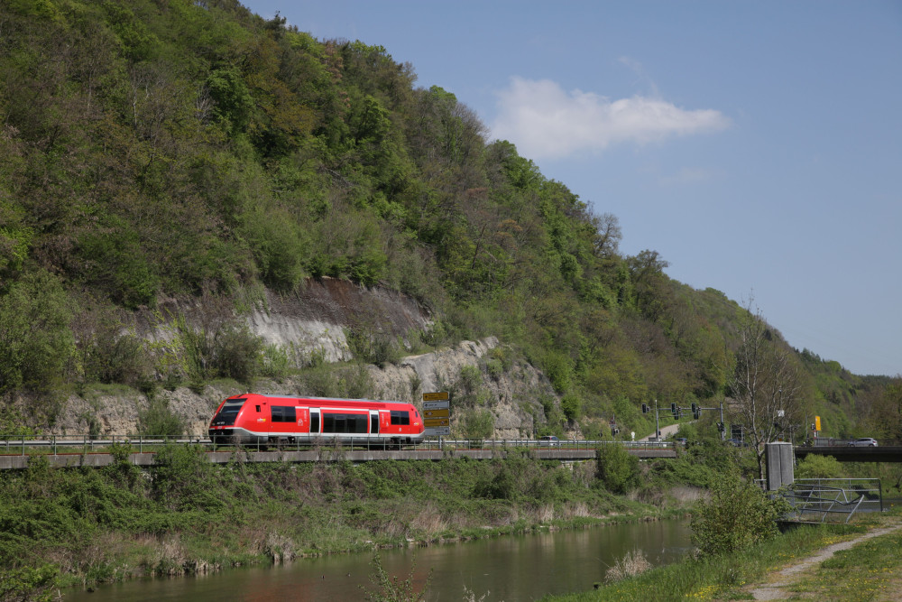Die rote Wutachtelbahn fährt durch eine grüne Landschaft