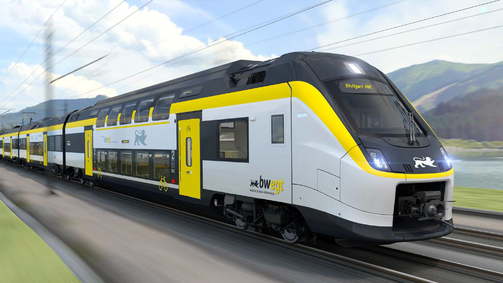 Ein Coradia Max Zug fährt durch eine grüne Landschaft